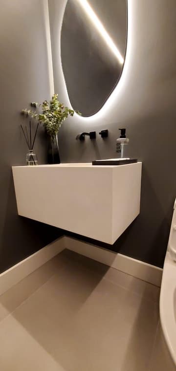 Bathroom remodel with a floating vanity and a backlit mirror