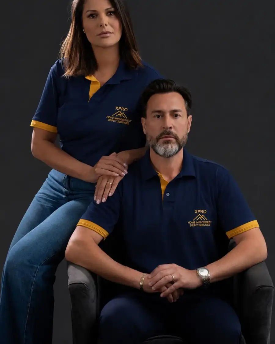 Two members of the XPRO team in navy XPRO polo shirts, studio portrait